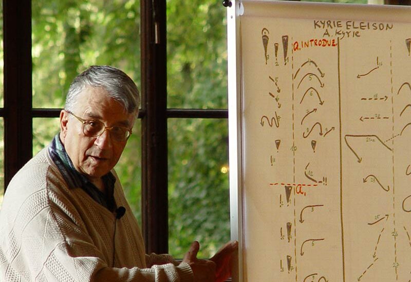 George Balan dando clase con un rotafolios mostrando la melorritmia de Kyrie Eleison